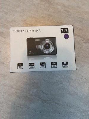 Digitalkamera 2.7K 48MP silver - Säljer en kompakt digitalkamera i silver med 2.7K videoupplösning, 48MP sensor och 16x digital zoom. Kameran har en stor LCD-skärm på baksidan och smidiga knappar för enkel navigering. Perfekt för dig som vill ta snygga bilder och filmer i hög kvalitet.