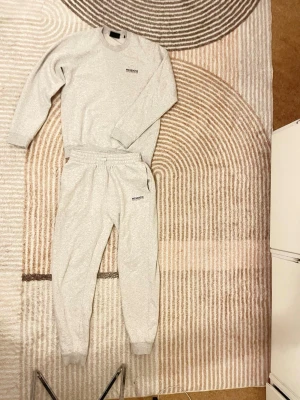 Grå mjukisbyxor från McKenzie - Säljer ett par ljusgrå mjukisbyxor från McKenzie med resår i midjan och muddar vid bensluten. Byxorna har en relaxed passform och är gjorda i mjukt bomullsmaterial. Perfekta för chill dagar eller när du vill vara extra bekväm.