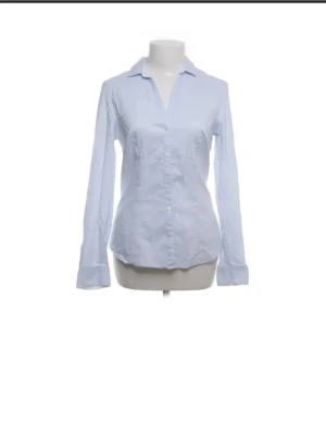 Blue shirt - Light blue long sleeve button-up shirt in very good condition. Classic and clean design that is easy to style. Can be worn both casual and dressed up.