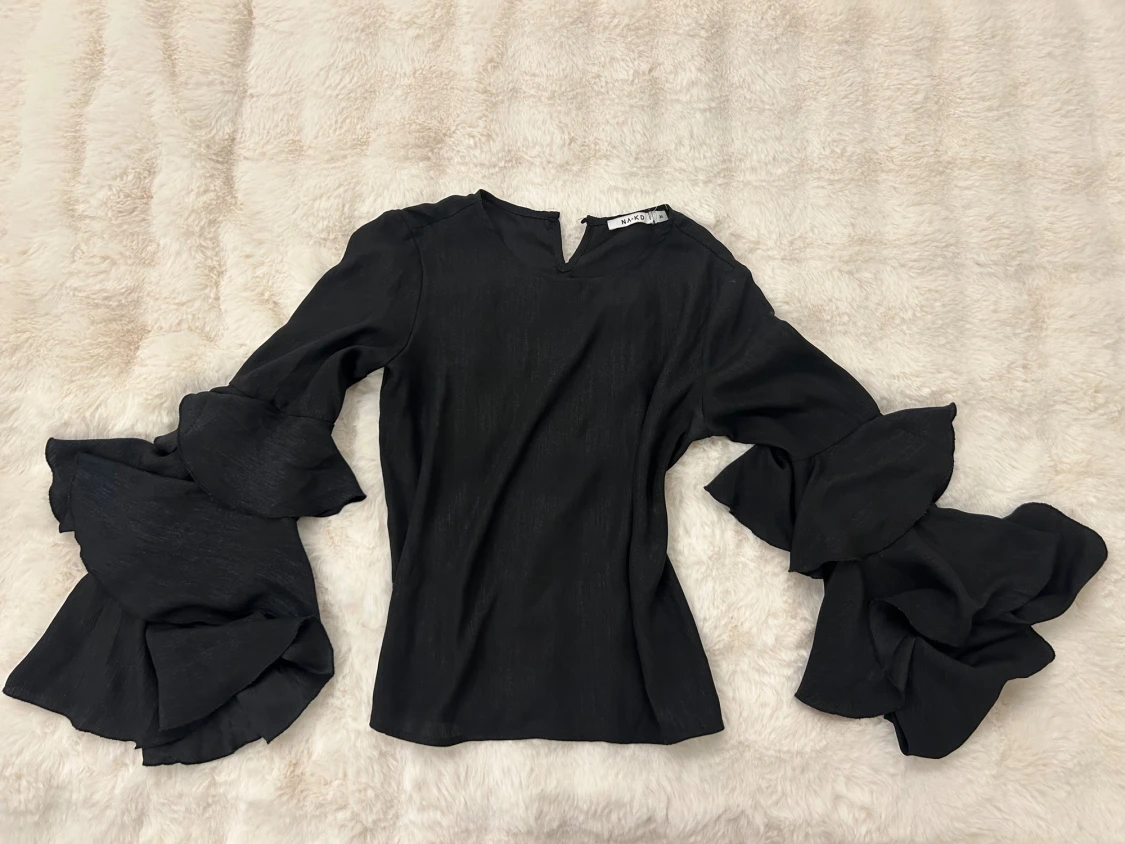 Svart blus med volangärmar från NA-KD