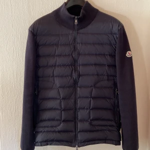 Moncler Cardigan - En Cardigan från Moncler i mörkblå och storlek L men passar även M. Jackan är i mycket bra skick. Originalpåse medföljer vid köp. Kan gå ner i pris vid snabb affär.
