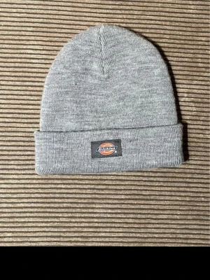 Grå Dickies Mössa - Grå Dickies mössa i bra skick. Bara att höra av sig vid frågor:)