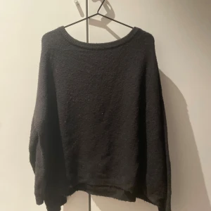 Svart stickad tröja med loose fit - Mysig svart stickad tröja med loose passform och rund hals.