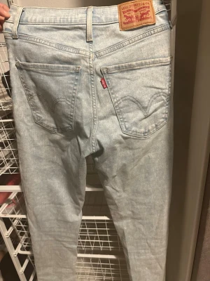 Levi's Mile High Super Skinny jeans ljusblå - Säljer ett par Levi's Mile High Super Skinny jeans i ljusblå tvätt. De har klassisk femficksdesign, hög midja och smal passform hela vägen ner. Jeansen är tillverkade i mjukt denim med Levi's ikoniska patch bak och röda logotagg på fickan.