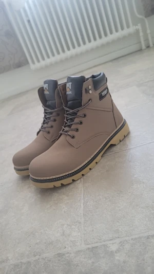 Vinterskor  - Snygga beige boots  med svart vadderad kant och grov sula. Skorna har snörning med svarta och vita skosnören samt rund tå. Perfekta för dig som gillar en robust och stilren look till höst och vinter. Dem är helt nya.