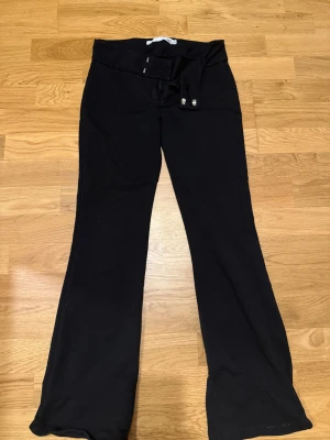 Svarta bootcut kostymbyxor - Svarta byxor med . Mjukt material som känns skönt mot huden och ger en avslappnad vibe. Perfekta för dig som gillar en klassisk look med lite edge.