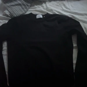 Svart tröja från Bläck, storlek S - En stilren svart tröja från Bläck i storlek S. Tröjan har rund halsringning och långa ärmar, perfekt för dig som gillar en clean och enkel look. Materialet är mjukt och skönt, passar bra till jeans eller chinos. Jätte bra skick, nypris 600kr