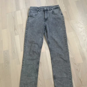 Grå slim fit jeans från &Denim - Snygga grå jeans från &Denim i slim fit-modell. Jeansen har klassisk femficksdesign, normal midja och raka ben. Materialet är mjukt denim som ger en skön känsla och cool tvättad look.