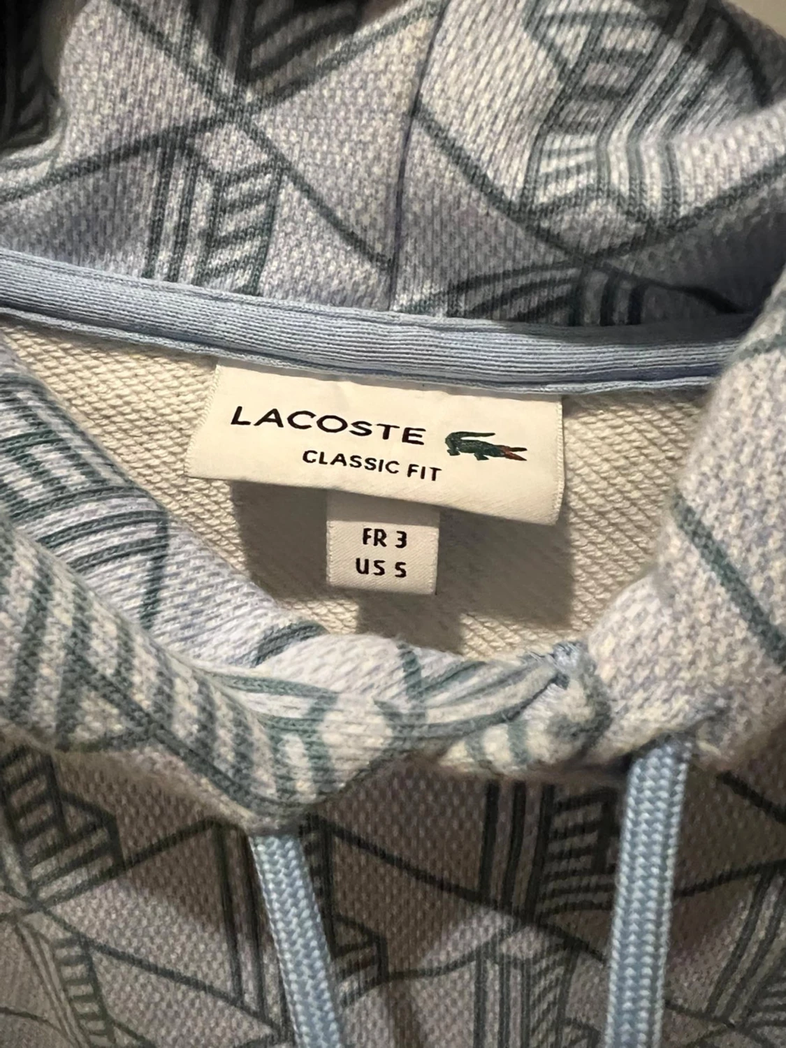 Ljusblå mönstrad hoodie från Lacoste - 1