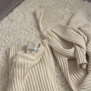 Beige ribbad stickad tröja och byxor Bluey Vanilla - Säljer en beige ribbstickad tröja och ett par supersköna mjukisbyxor  från Blue Vanilla. Tröjan har lång ärm, rund halsringning och är gjord i ett mjukt stickat material. Perfekt för lager-på-lager och chill vibes. Passar dig som gillar en enkel men snygg look. Byxorna är perfekt som pyjamasbyxor och är mycket varma!⚡️💓⛈️