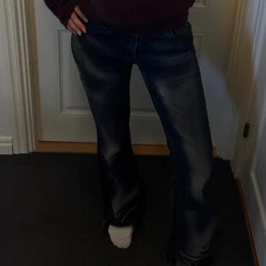 Mörkblå bootcut jeans med slitningar - Säljer ett par coola mörkblå jeans från Levis med bootcut-modell och snygga slitningar. Jeansen har låg midja. Perfekta för dig som gillar en lite vidare passform nertill och cool tvätt. Hör av er vid eventuella frågor!🥰
