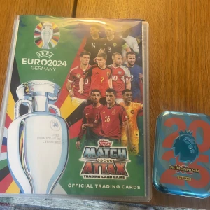 UEFA Euro 2024 Match Attax Official Trading Cards and premier league 2025 Cards  - Samlarpärm med officiella Match Attax trading cards från UEFA Euro 2024 och premier league kort. Perfekt för dig som älskar fotboll och vill samla på stjärnspelare, legender och specialkort. Färgglada och coola kort som gör samlandet extra spännande för unga fans! Och bra skick. Om ni tycker att priset är för högt så får ni Järna skriva om ni tycker det är för högt så kan jag sänka det!!! (:
