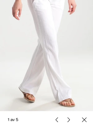 Vita linnebyxor - Snygga vita linnebyxor med wide passform och avslappnat fall. Byxorna har hög midja och är tillverkade i lätt och luftigt linne, perfekt för varma dagar. Stilen är enkel och fräsch, med raka ben och diskreta fickor framtill. Säljer då de är förstora för mig❤️