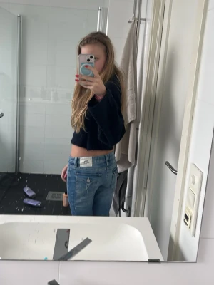 Gina ljusblå jeans med slitningar - Säljer ett par klassiska gina jeans i ljusblå tvätt med snygga hål och knäna. Jeansen är boutcut, normal midja. Perfekta för en avslappnad och trendig look.