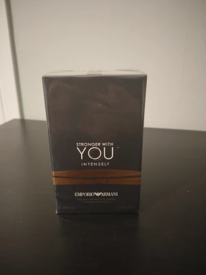 Emporio Armani Stronger With You Intensely - Emporio Armani Stronger With You Intensely är en parfym i en elegant svart och kopparfärgad förpackning. Flaskan rymmer 100 ml och har en modern, stilren design. Doften är intensiv och maskulin, perfekt för dig som vill sticka ut med en unik signaturdoft.