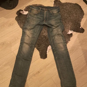 Nudie Jeans W30 L32 - Säljer ett par riktigt snygga blå jeans från Nudie i mycket bra skick. Nypris ca 1600. Har tyvärr växt ut de. Perfekta för dig som gillar straight, lite mer slim passform