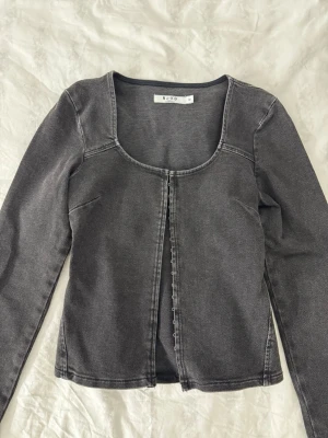 Mörkgrå croppad topp från NA-KD - Mörkgrå jeanstopp från NA-KD. Helt ny och oanvänd!