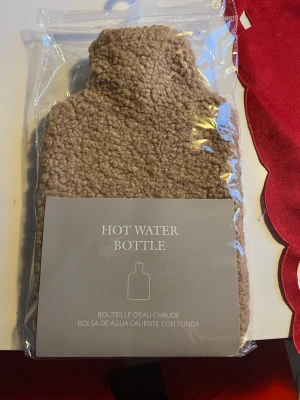 Beige teddyväst med fluffig yta - Säljer en beige teddyväst med mjuk och fluffig yta som ger en riktigt mysig känsla. Västen har en klassisk rak form och är tillverkad i syntetmaterial som påminner om fårull. Perfekt för att addera lite extra värme och stil till din outfit.