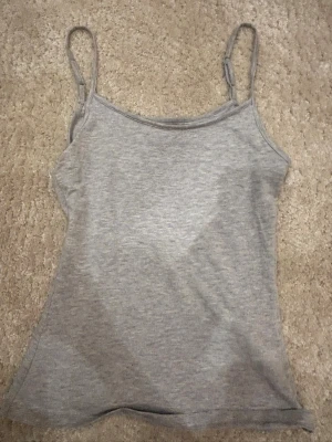 Grå linnetopp från Anna Field - En enkel och stilren grå linnetopp från Anna Field med smala axelband. Perfekt att matcha med jeans eller kjol. Mjuk och bekväm, passar till många olika looks.