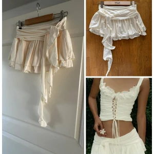 Vit omlottkjol med volang och knytband M - Supersöt vit kortkjol med omlottmodell och långa knytband i midjan. Kjolen har volangkant och är tillverkad i ett mjukt, lätt material som ger en flowy känsla. Perfekt för dig som gillar romantiska och trendiga plagg med extra detaljer. Korea brand