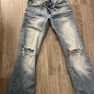 Blå slitna jeans från Nelly - Snygga blå jeans från Nelly med slitningar och stora hål vid knäna. Även gjort egna hål högre upp på högre sidan. Tagit bort ”ficklappen” på bakfickorna men om man vill få bort den mörka överfärgen behöver de blekas där. Nypris 699kr men pga av allt jag exproprierat på jeansen säljer jag de för 50kr.