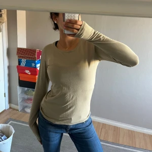 Fin grön långärmad tröja i bomull  - En basic långärmad tröja från Cubus i ekologisk bomull. Tröjan har rund halsringning och en slim passform. I storlek Xs, har en pyttelitet hål på baksidan (kolla bild) annars nyskick! Rensar garderoben, kolla in mina andra kläder så får ni rabatt ju fler plagg ni köper!🥰