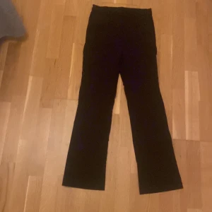 Svarta bootcut-byxor från Stories - Snygga svarta byxor från gekås i storlek 34. De har en klassisk bootcut-passform med lite utsvängda ben och hög midja. Andvänt 2 gånger.