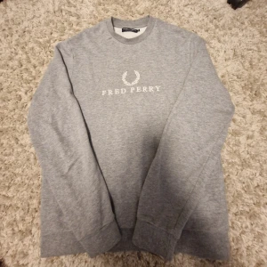 Grå sweatshirt från Fred Perry - Säljer en stilren tvär snygg tröja från fred perry. Nästa aldrig använd. Pris är ej fast!
