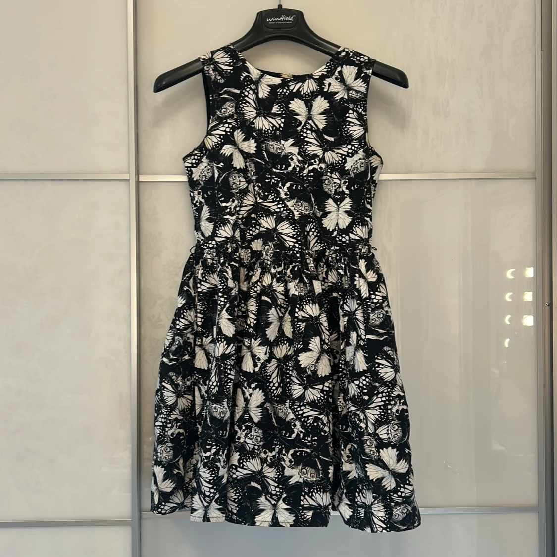 Svartvit ärmlös klänning med fjärilar