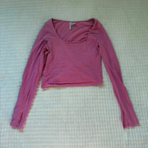 Rosa croppad långärmad topp H&M - En rosa croppad långärmad topp från H&M Divided. Toppen har en rundad, lite djupare ringning och är tillverkad i mjuk bomull. Perfekt att styla med jeans eller kjol för en chill look.