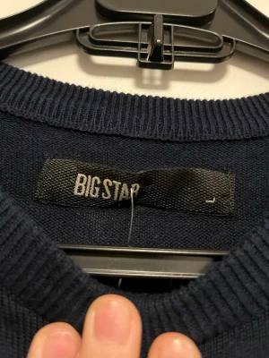 Marinblå randig tröja från Big Star - Snygg marinblå långärmad tröja från Big Star med vita horisontella ränder. Tröjan har rund hals och är tillverkad i mjuk bomull, perfekt för dig som gillar klassisk och chill stil. Passar dig som vill ha en enkel men stilren look.