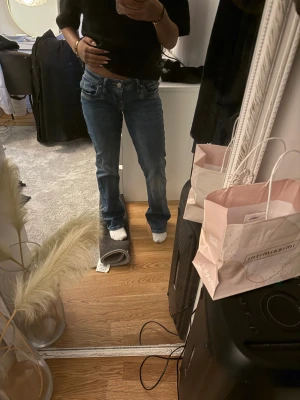 Blå bootcut jeans från LTB - Snygga blå jeans från LTB med klassisk bootcut-modell och normal passform. Jeansen har fem fickor, låg midja och är tillverkade i ett mjukt denimtyg. Perfekta för dig som gillar en tidlös och avslappnad stil.