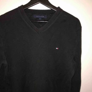  - Tommy Hilfiger V-neck sweatshirt, inköpt 2018 på Tommy Hilfiger store i Stockholm. Tröjan är använd men i fint skick, storlek L. Färg:Svart Pris:150kr Kan gå billigare vid snabb affär.
