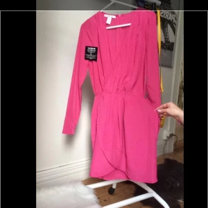  - Jättefin siden liknande klänning i rosa/cerise. Strl XS/34 från Nelly, inte använd 