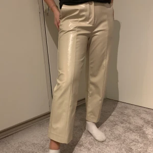 Fake skin / lack byxor - Vida kroppade lack byxor i en ljus beige färg. Från weekday storlek 36. Super fina och i bra skick! Oanvända pga för små i midjan. Ordinariepris 499kr, säljer för 150kr + frakt.