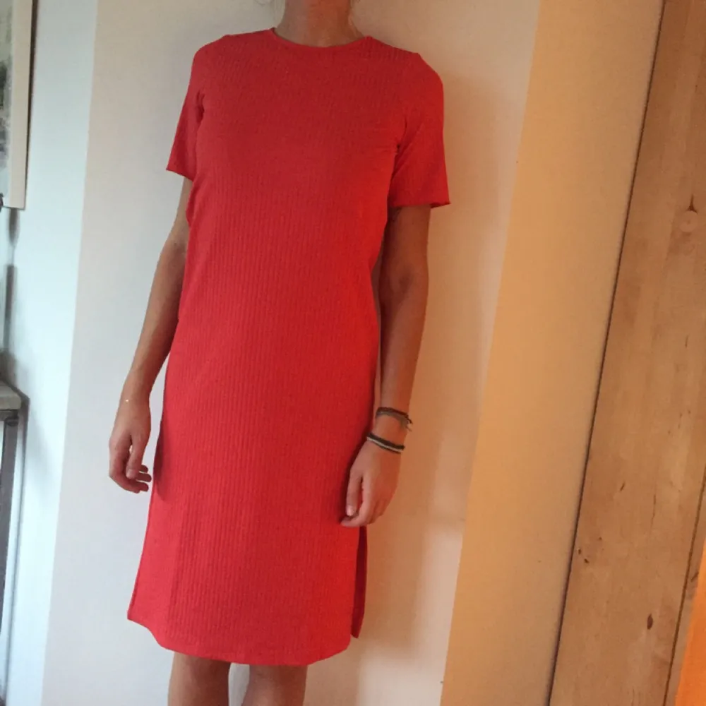 Tshirtklänning från Asos i röd/rosa korallfärg. Två slitsar vid sidorna, köpt i våras och aldrig använd. Storlek 36. Swish och du står själv för frakt! (Jag är 180cm lång). Klänningar.