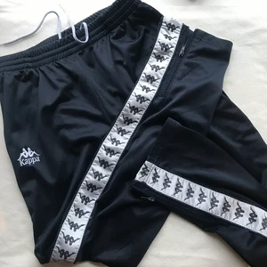 Kappa byxor  - Trackpants från kappa. Herrmodell men passar alla imo. Lite slitna och sömmen har gått upp på benet en bit och lite slit mellan benen men går att laga enkelt. Står xl men mer som L och går att ha oversize! Köpare står för frakt, möts ej upp! 🌸