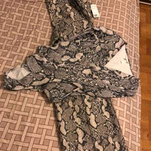 Set for two body plus trouser snake print.New with tags.Bought for 449 together.Selling for 200