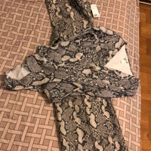  - Set for two body plus trouser snake print.New with tags.Bought for 449 together.Selling for 200