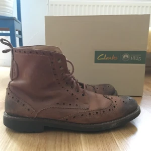  - Clarks läderboots i dark tan, använda men i snyggt skick. Köpta för 1499 kr. Kan mötas upp i Uppsala eller Stockholm, annars står köparen för frakt. 