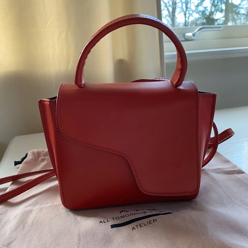 En röd ATP atelier Montalcino väska. Väskan är varsamt använd och är därför i mycket bra skick som visas på bilden. Pris kan diskuteras . Väskor.