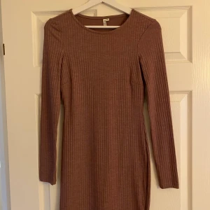 Nelly klänning - Brun/lilla/nude klänning från Nelly. Aldrig använd, bra skick. Fraktkostnad tillkommer 