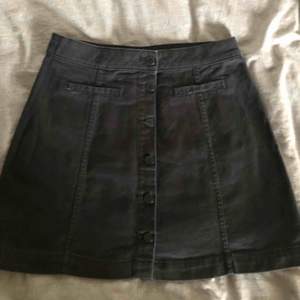 Fin svart jeans kjol med knappar och fusk fickor på vardera sida, kjolen kommer från hm och är använd högst 3 gånger. 
