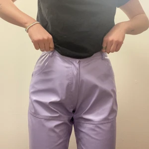 Lila skinnbyxor - Jättefina ljuslila byxor i skinnimitation, omsydda! Passar nog M bäst. 🤍
