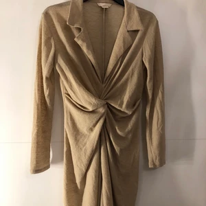 Beige klänning  - Beige klänning från H&M med knut i mitten. Använd ett fåtals gånger, helt felfri. 