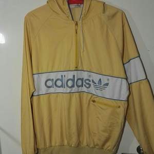 Incredibly stylish adidas original yellow hoodie. The size has been blotted out but guesses on size M.