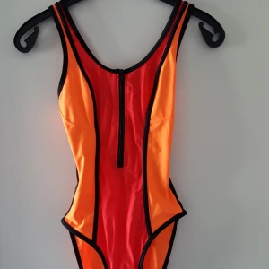  - Neonfärgad baddräkt i storlek 38/40. Kan skickas om köparen står för frakten, som då blir 36kr.