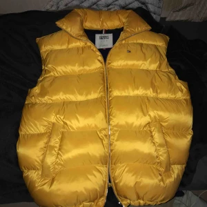  - tjock dunväst från Tommy, i nyskick! den är oversize i storleken så passar även en S  ord. pris ca 1800)